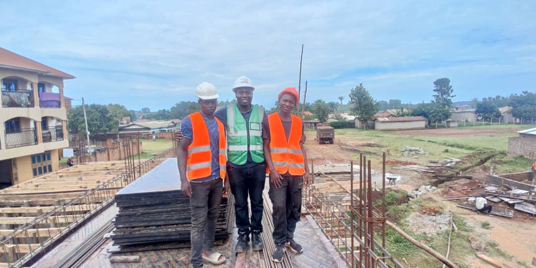 Professional engineers reviewing construction blueprints on site